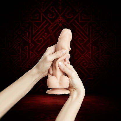 Hands holding a small figurine against a dark red background with intricate patterns